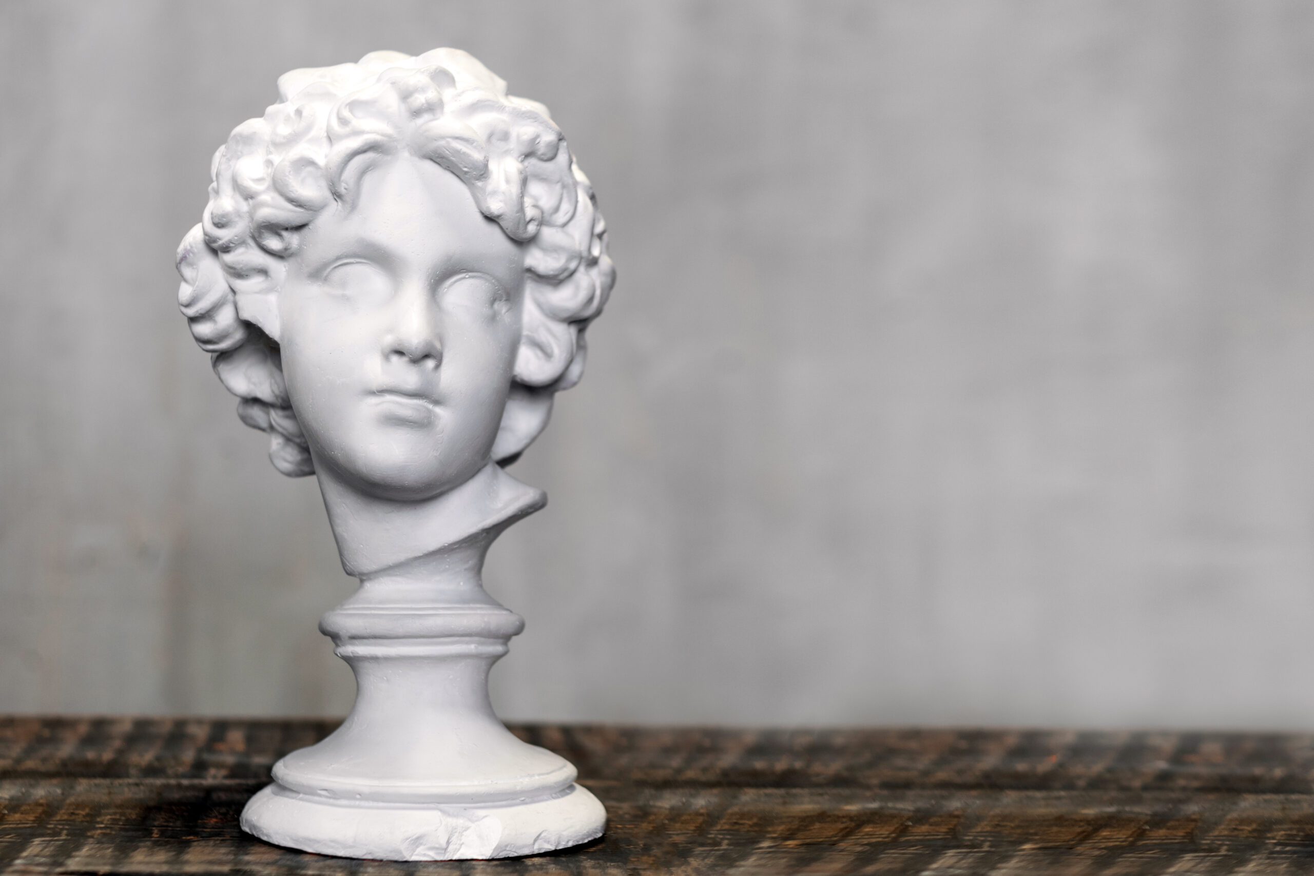Young man bust, gypsum plaster sculpture. Copyspace for text.