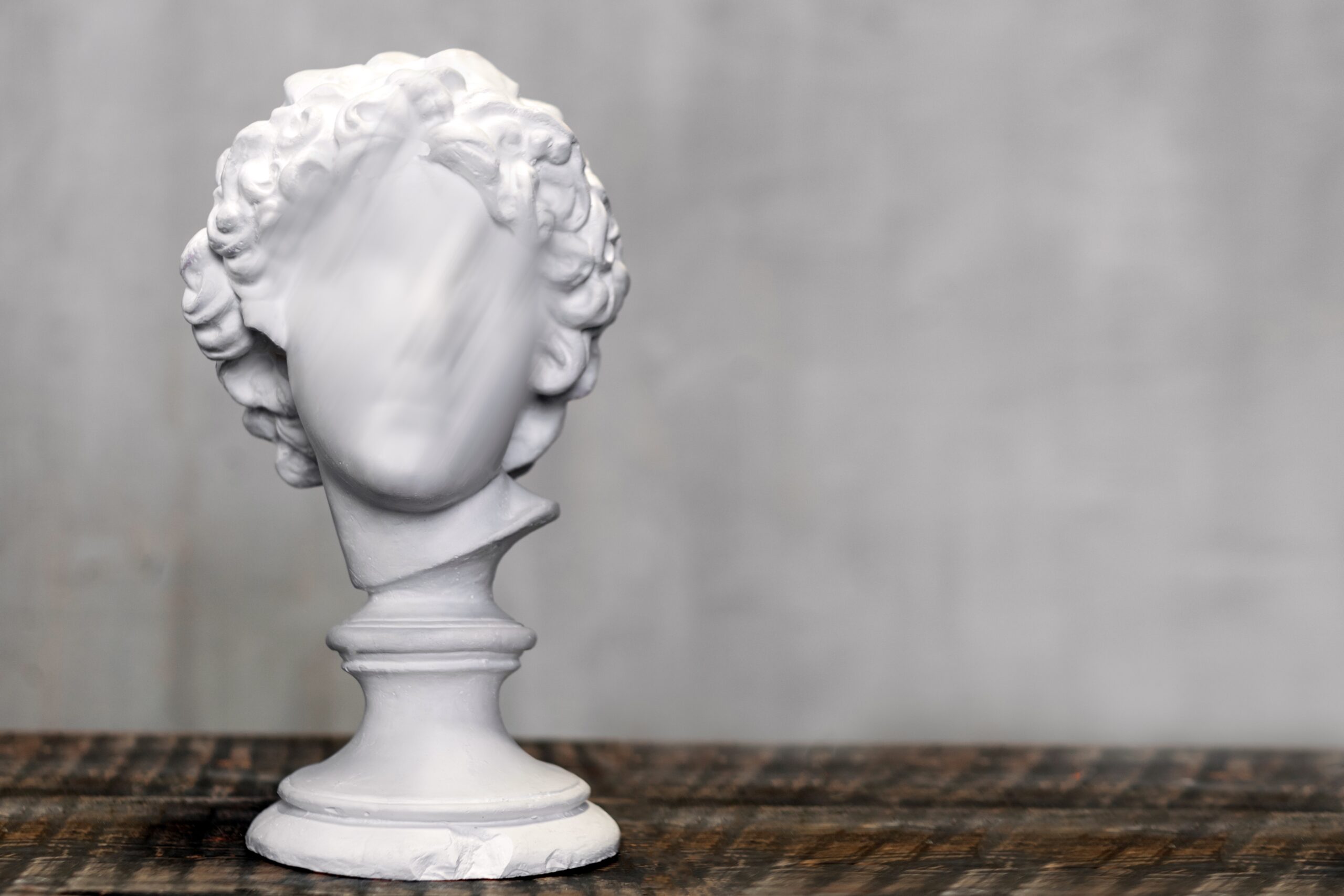 Young man bust, gypsum plaster sculpture. Copyspace for text.